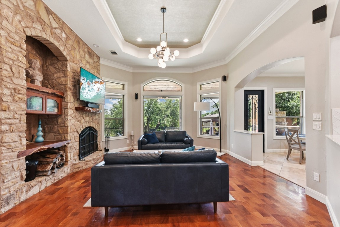 122 Silverstone Drive Georgetown, TX 78633 - Photo 15 of 40 a living room with furniture a fireplace and a chandelier