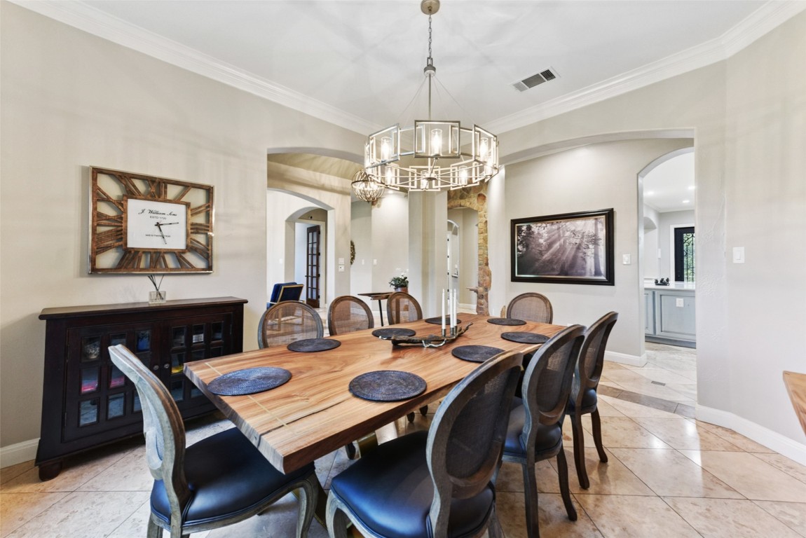 122 Silverstone Drive Georgetown, TX 78633 - Photo 17 of 40 a view of a dining room with furniture and a chandelier