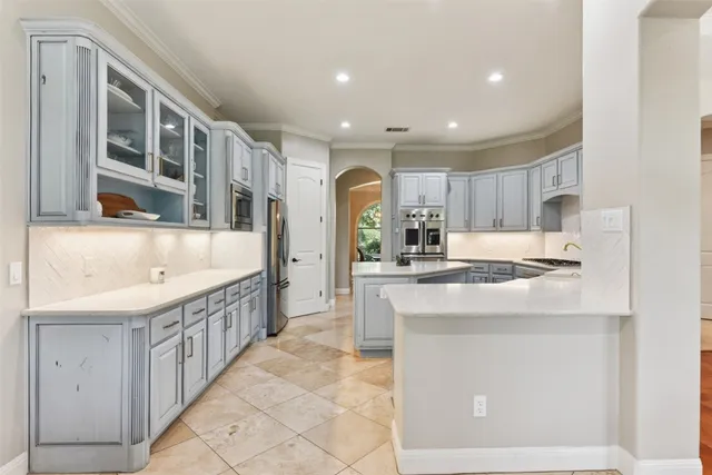 a kitchen with a sink stove and refrigerator