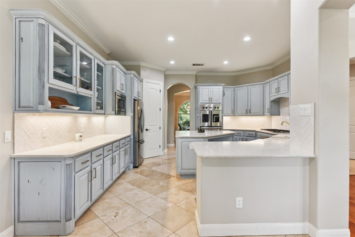 122 Silverstone Drive Georgetown, TX 78633 - Photo 19 of 40 a kitchen with stainless steel appliances granite countertop a sink and a refrigerator