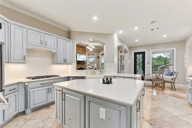 a kitchen with stainless steel appliances granite countertop a refrigerator and microwave