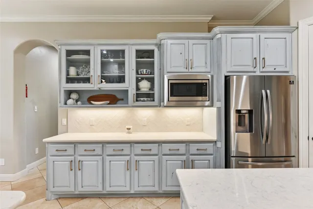 a kitchen with granite countertop a stove sink and cabinets