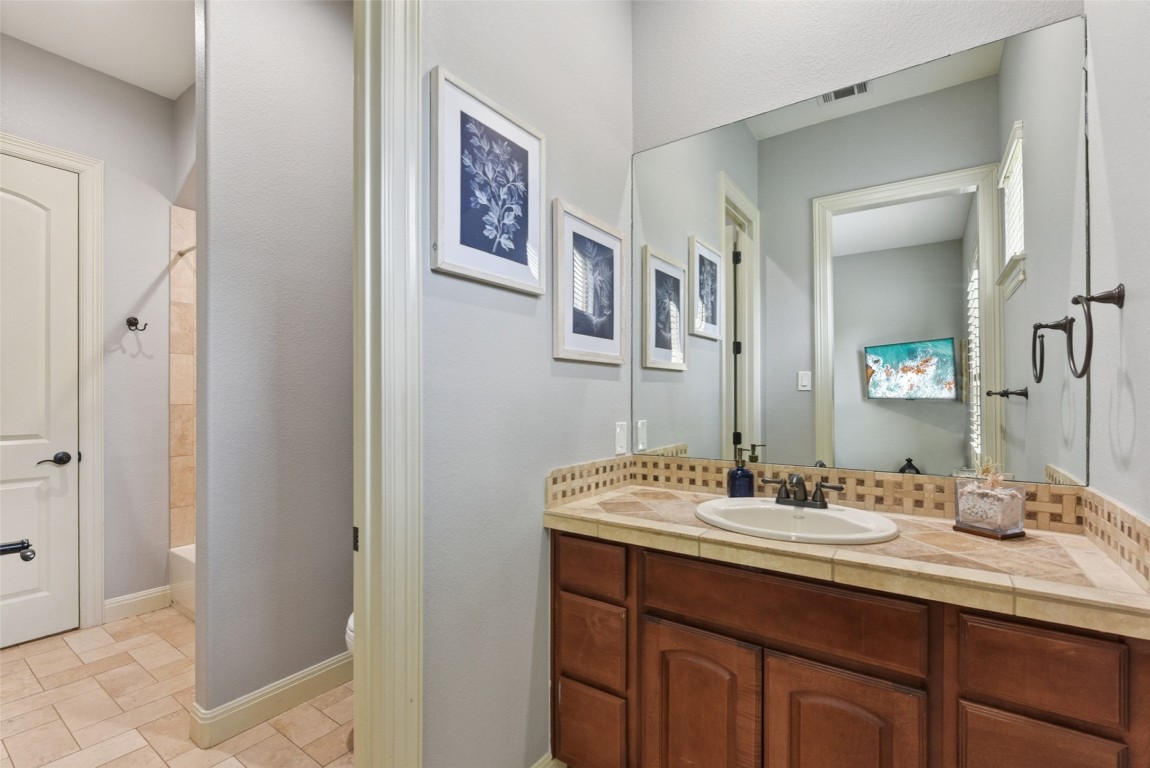 122 Silverstone Drive Georgetown, TX 78633 - Photo 27 of 40 a bathroom with a sink and a mirror