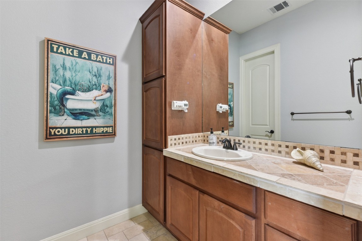 122 Silverstone Drive Georgetown, TX 78633 - Photo 29 of 40 a bathroom with a sink and a mirror
