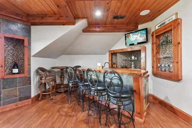 a living room with furniture a flat screen tv and a potted plant