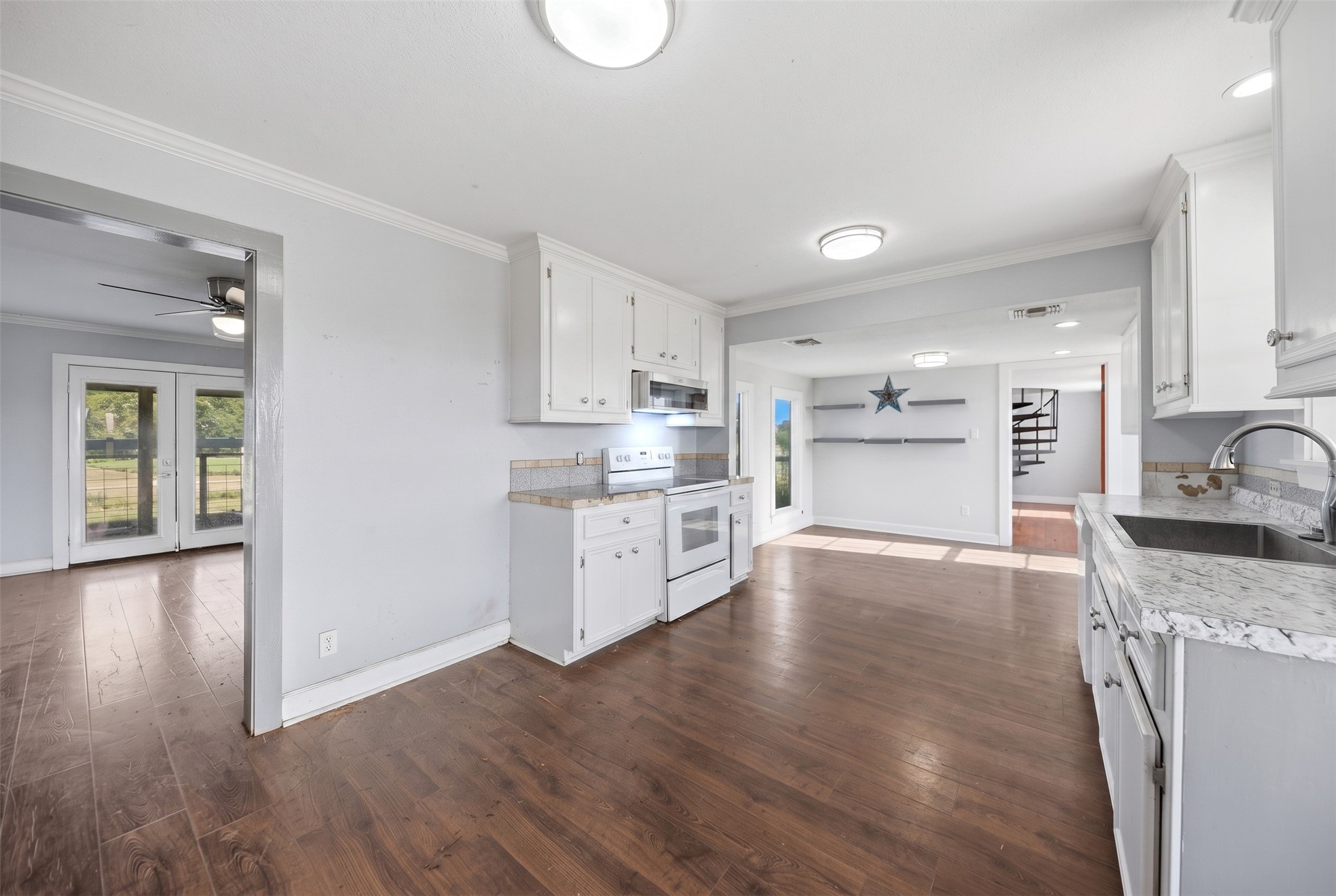 2980 Rabbs Prairie Road La Grange, TX 78945 - Photo 8 of 28 A well-appointed kitchen showcases rich wood flooring and crisp white cabinetry.