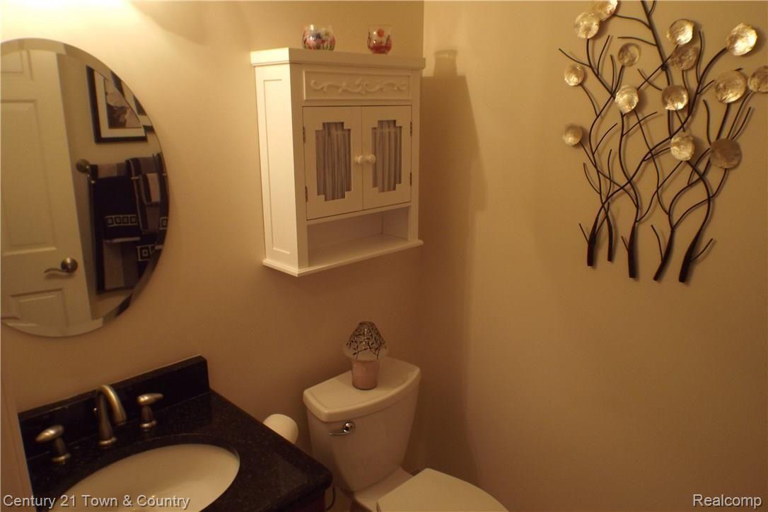 6384 Perry Road Grand Blanc, MI 48439 - Photo 37 of 77 Half bath off garage Cherry cabinet, granite counter top, quality faucet and fixture.