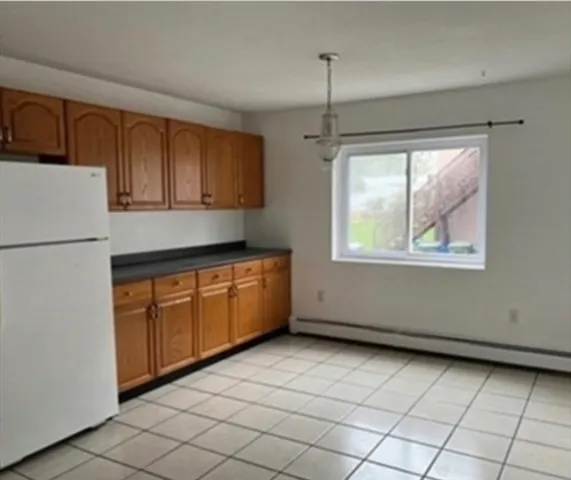 a kitchen with stainless steel appliances granite countertop a refrigerator a stove top oven and a sink with dishwasher