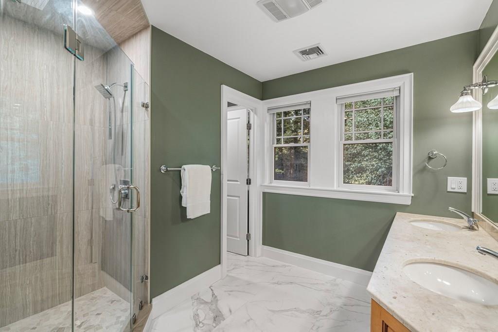 150 Wellesley Street Weston, MA 02493 - Photo 18 of 31 a bathroom with a granite countertop sink a shower and a mirror
