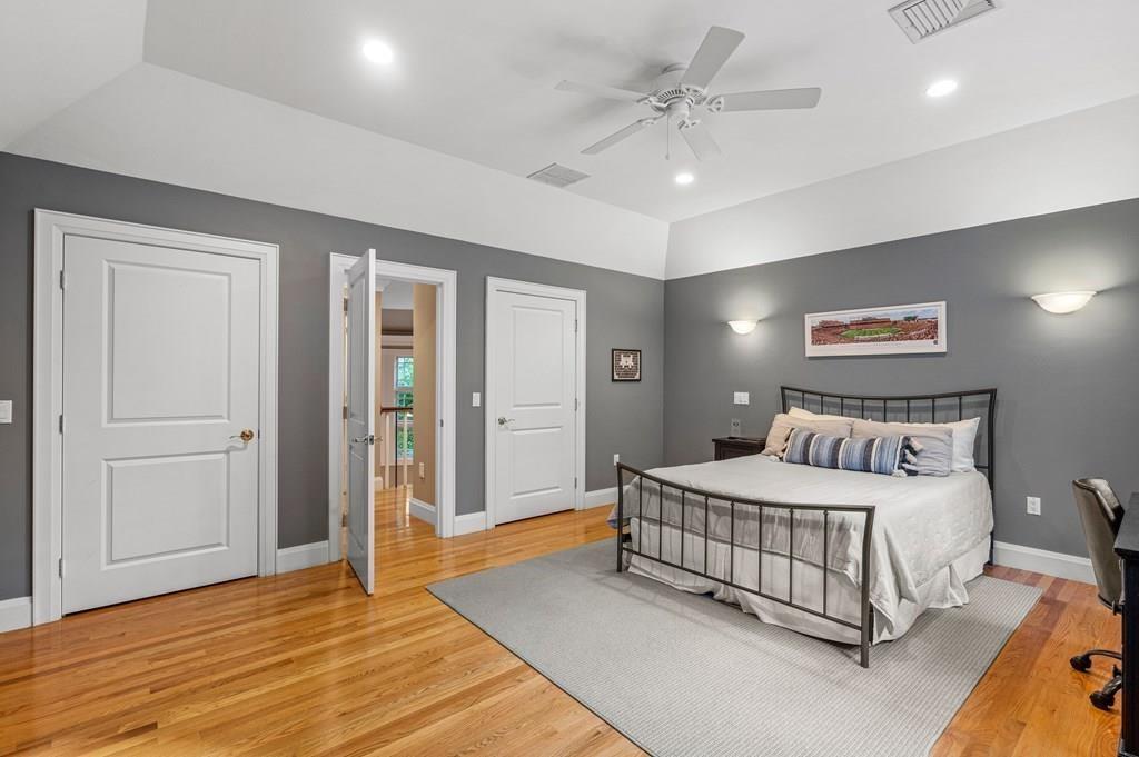 150 Wellesley Street Weston, MA 02493 - Photo 20 of 31 a bedroom with a large bed and a chandelier