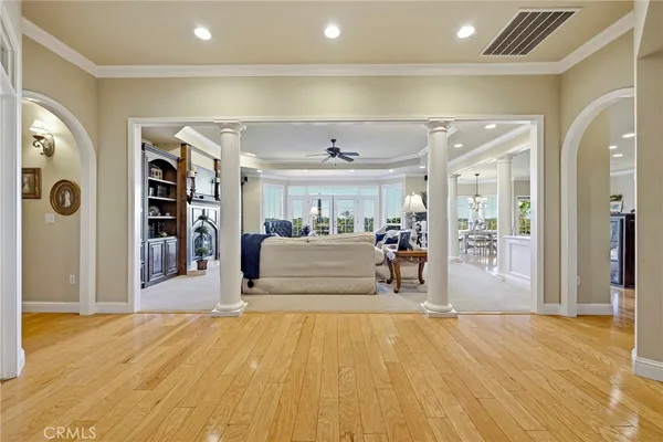 a bedroom with a large bed and a chandelier