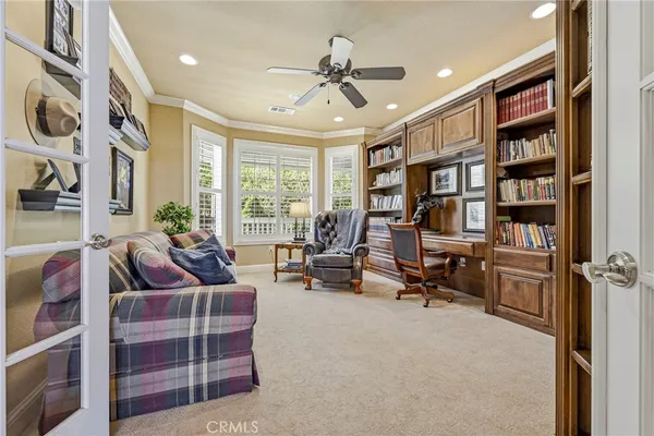 a kitchen with stainless steel appliances kitchen island granite countertop a refrigerator a oven and a stove with wooden floor