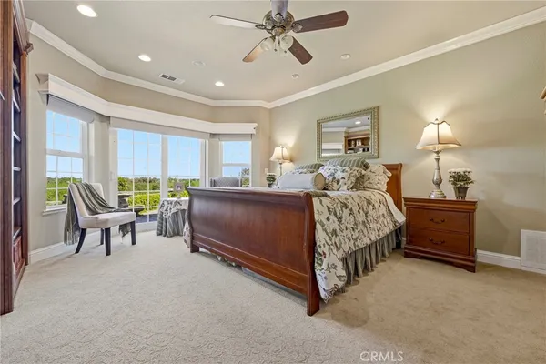 a spacious bedroom with a bed and a window