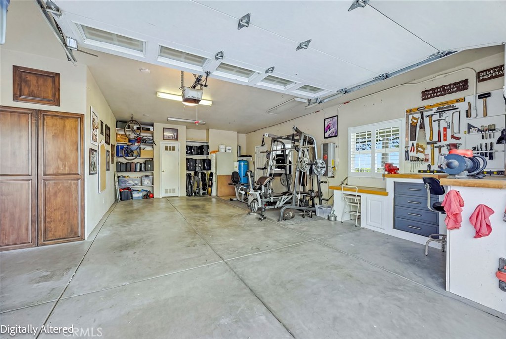 11126 Livingston Cressey Road Livingston, CA 95334 - Photo 73 of 75 Single garage door with built in shelving and space for gym and workbench