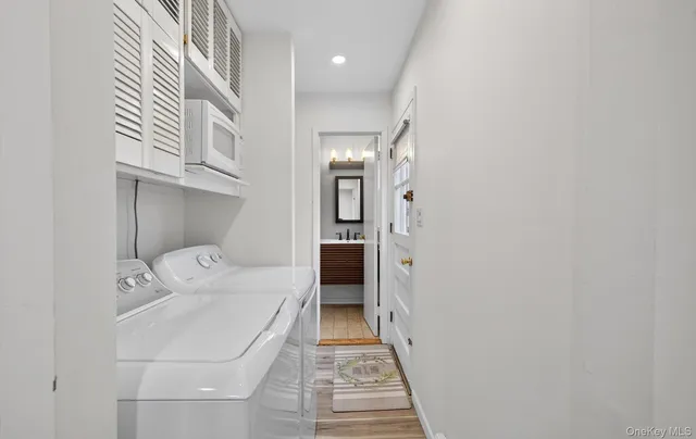 a bathroom with a granite countertop sink vanity mirror and toilet