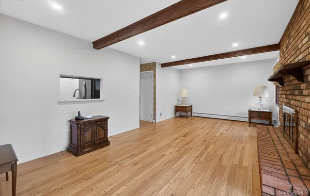 a living room with furniture a fireplace and wooden floor