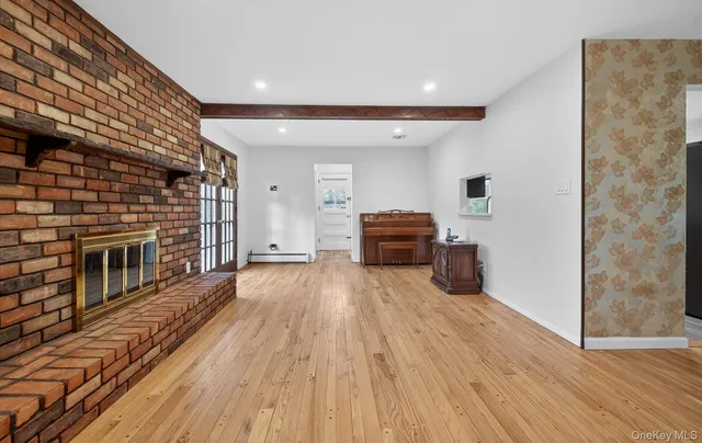 a living room with furniture wooden floor and a fireplace