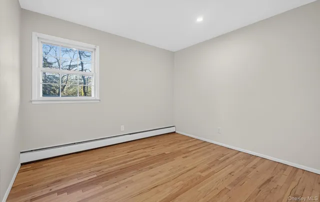 a bedroom with a bed and a lamp on dresser