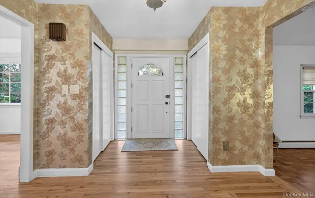 a view of entryway and hall with wooden floor