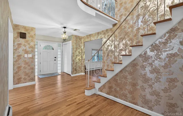 a view of a room with wooden floor and white walls