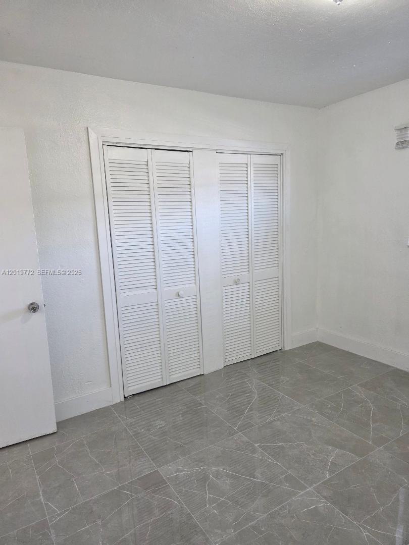 340 West 19th Street, Unit 2 Hialeah, FL 33010 - Photo 8 of 10 an empty room with closet area