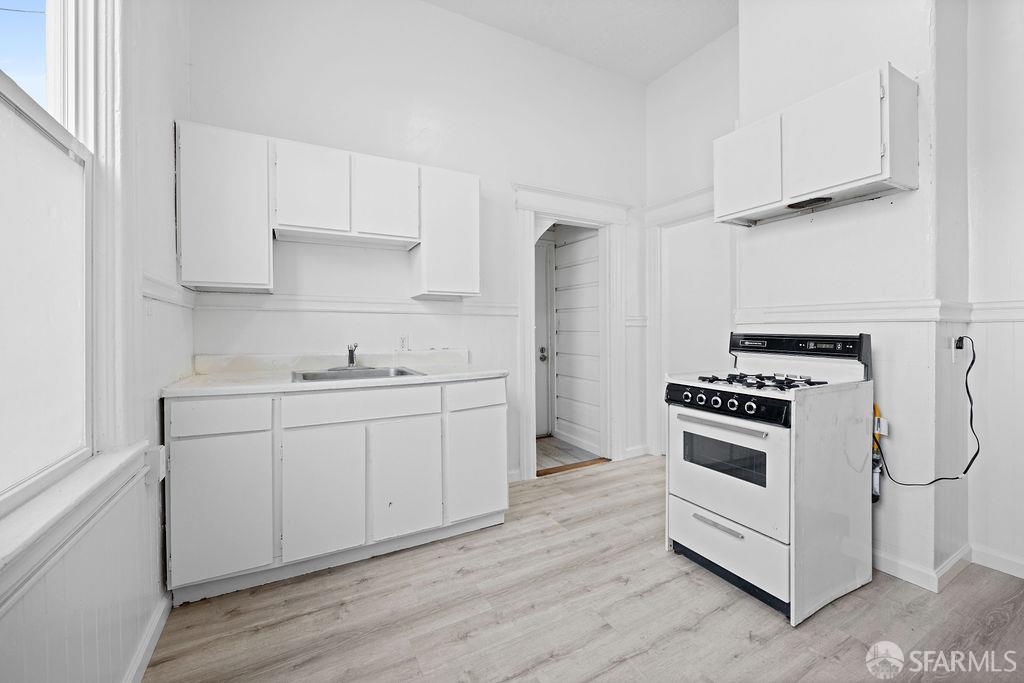 2401 23rd Street San Francisco, CA 94110 - Photo 16 of 76 a kitchen with cabinets appliances a sink and a counter space