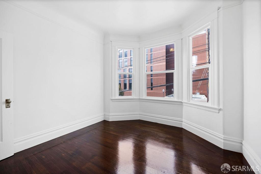 2401 23rd Street San Francisco, CA 94110 - Photo 27 of 76 a view of an empty room with wooden floor and a window