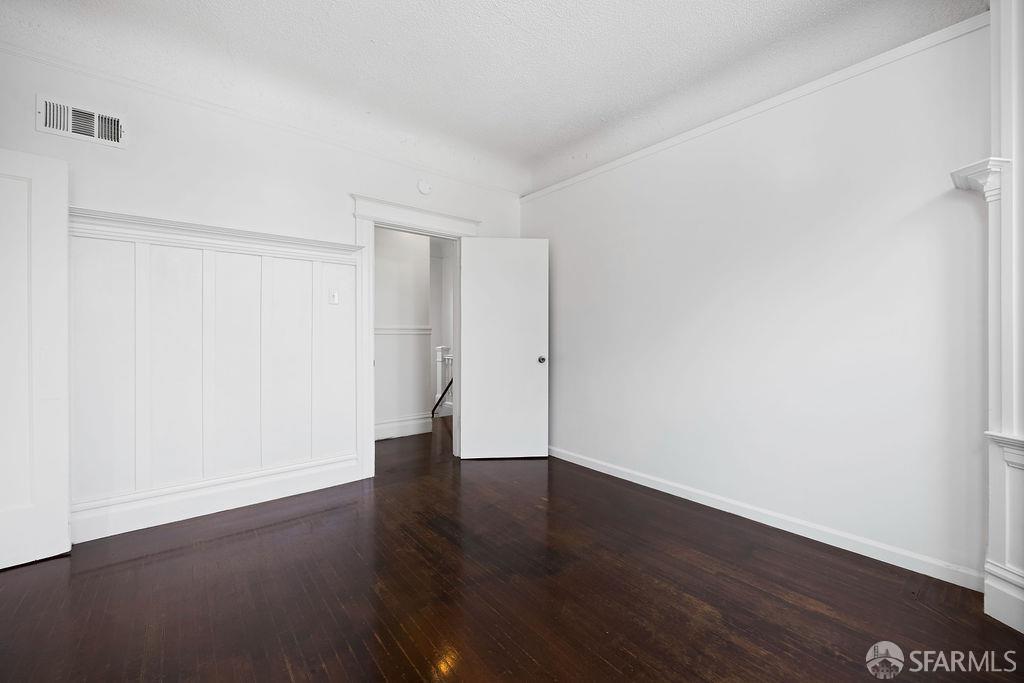 2401 23rd Street San Francisco, CA 94110 - Photo 39 of 76 a view of an empty room with wooden floor