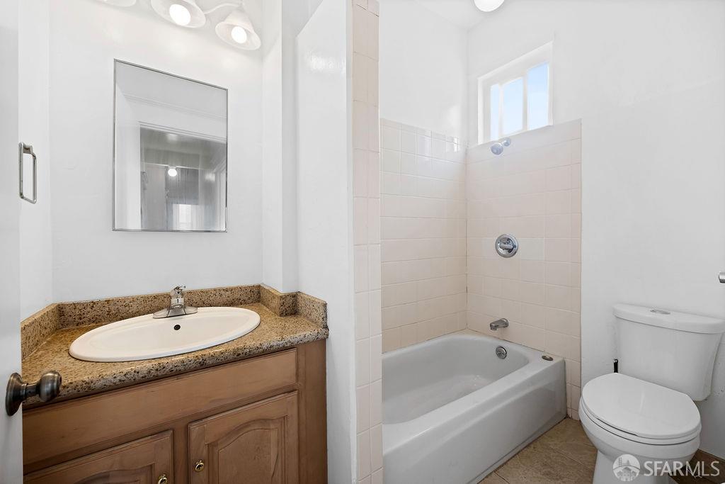 2401 23rd Street San Francisco, CA 94110 - Photo 47 of 76 a bathroom with a granite countertop sink a toilet and bathtub