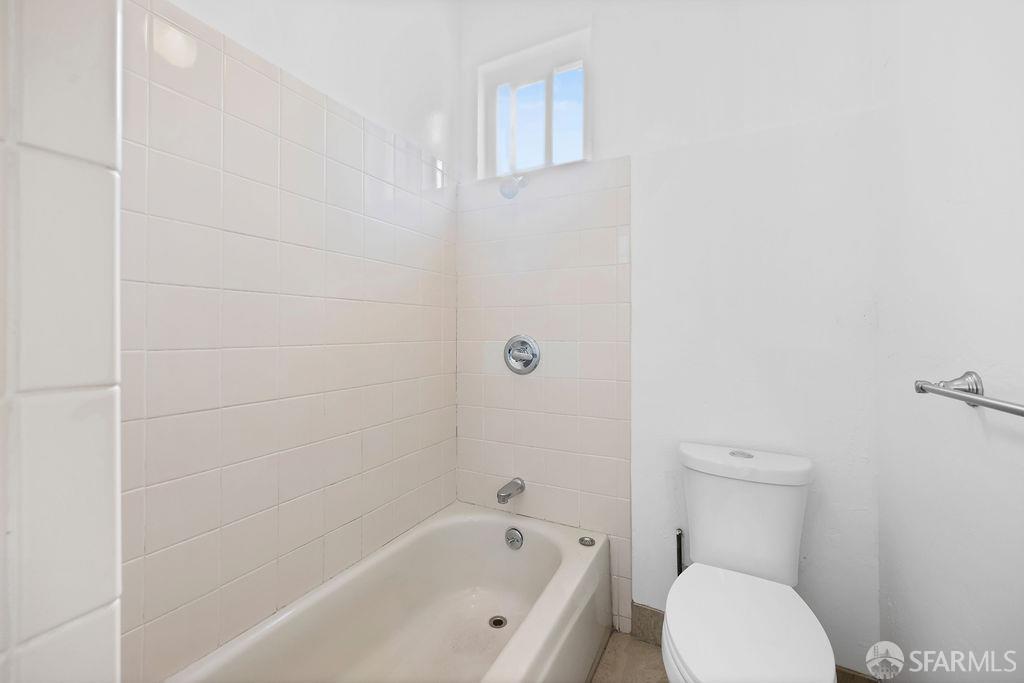 2401 23rd Street San Francisco, CA 94110 - Photo 48 of 76 a white toilet sitting next to a bath tub