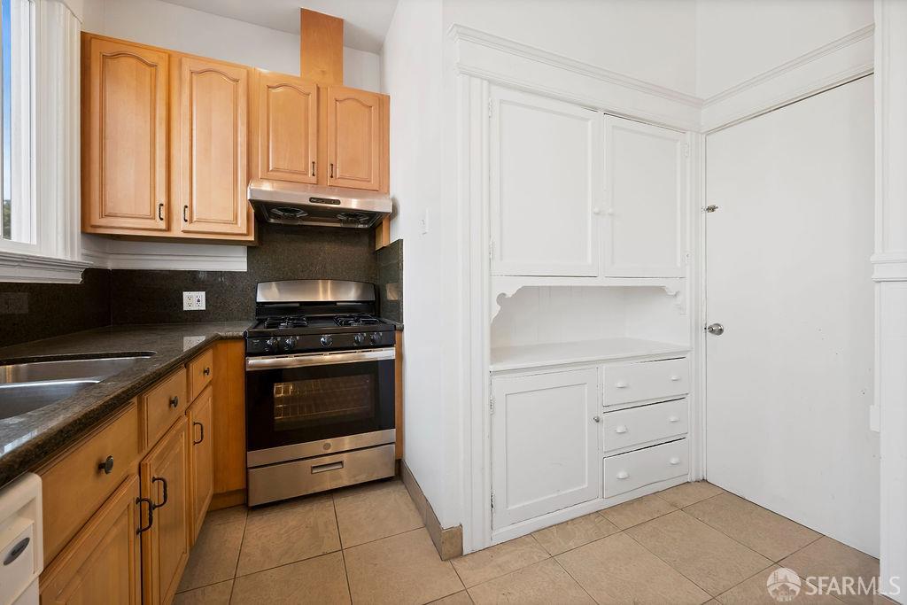2401 23rd Street San Francisco, CA 94110 - Photo 52 of 76 a kitchen with granite countertop white cabinets and appliances