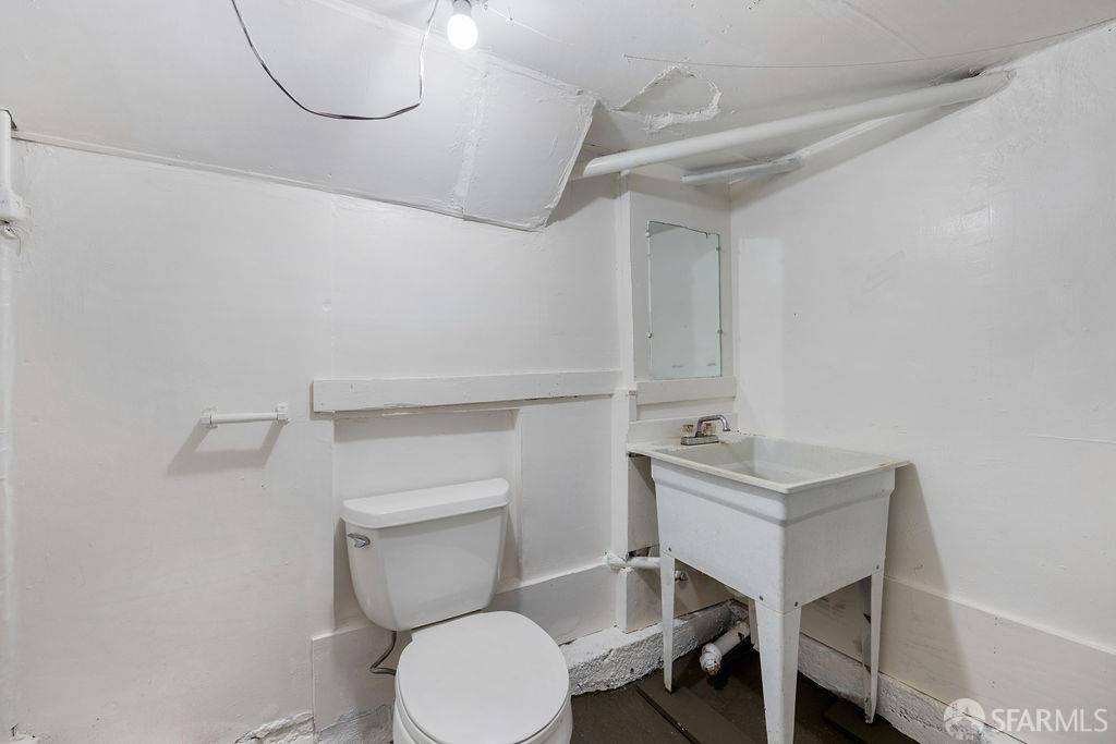 2401 23rd Street San Francisco, CA 94110 - Photo 75 of 76 a bathroom with a sink a toilet and a mirror