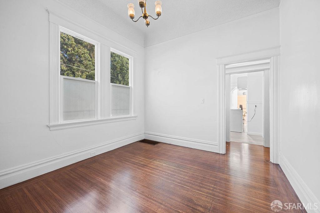 2401 23rd Street San Francisco, CA 94110 - Photo 8 of 76 a view of an empty room with wooden floor and a window