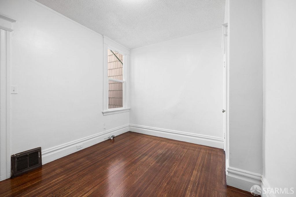 2401 23rd Street San Francisco, CA 94110 - Photo 10 of 76 a view of an empty room with wooden floor and a window