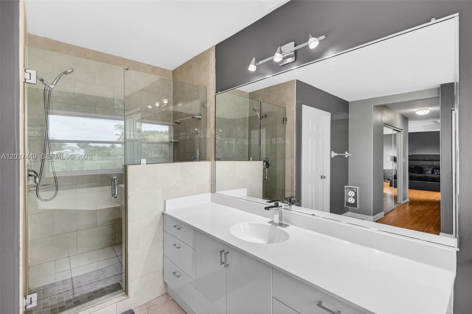 17488 Southwest 28th Court Miramar, FL 33029 - Photo 26 of 50 a bathroom with a sink shower and a mirror