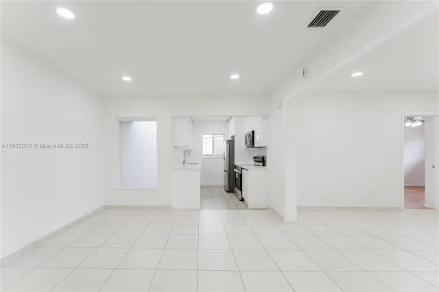 an empty room with white walls and white walls