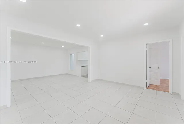 an empty room with white walls and tiles