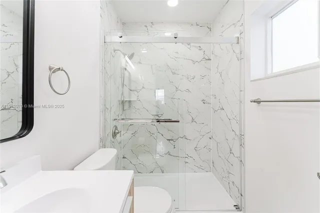 a bathroom with a toilet and a shower