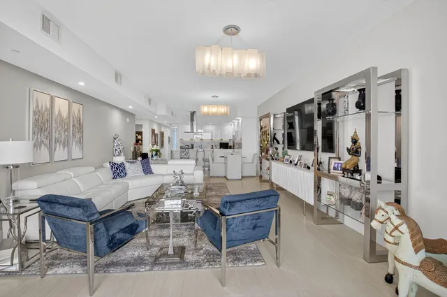 a living room with furniture a flat screen tv and a window