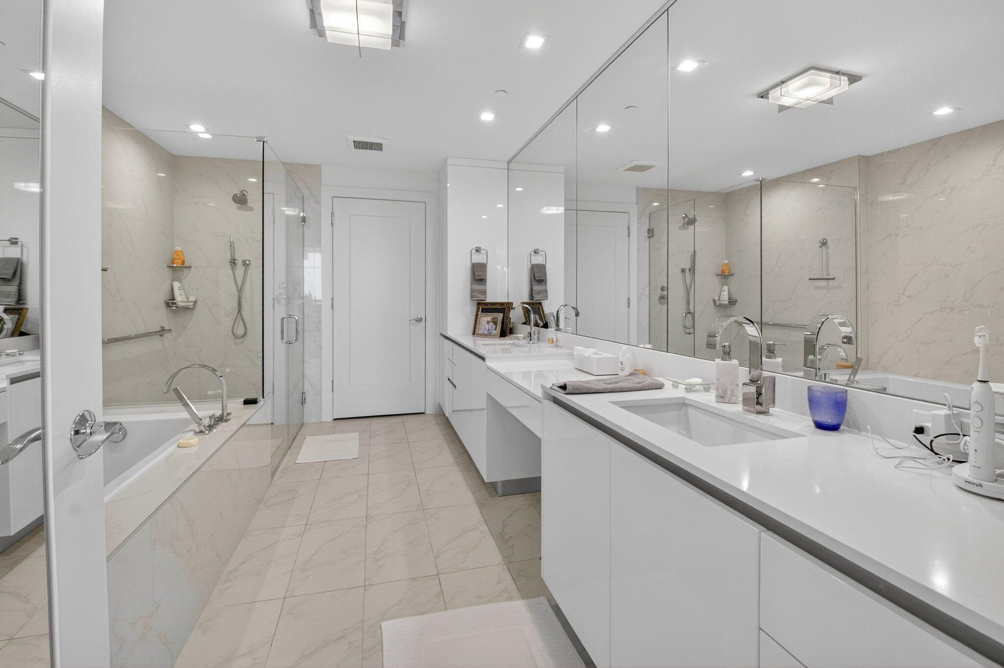20155 Boca W Drive, Unit C205 Boca Raton, FL 33434 - Photo 24 of 122 a bathroom with a double vanity sink mirror double shower and bathtub
