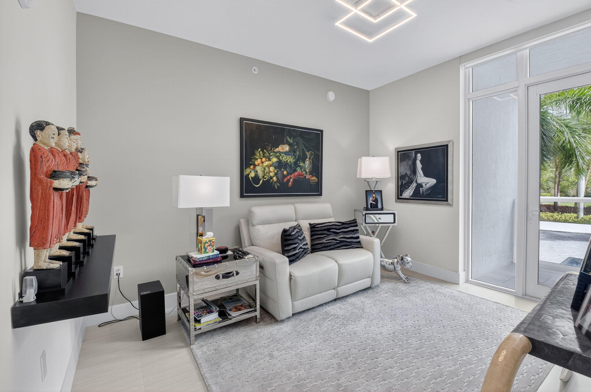 20155 Boca W Drive, Unit C205 Boca Raton, FL 33434 - Photo 39 of 122 a living room with furniture a flat screen tv and a window