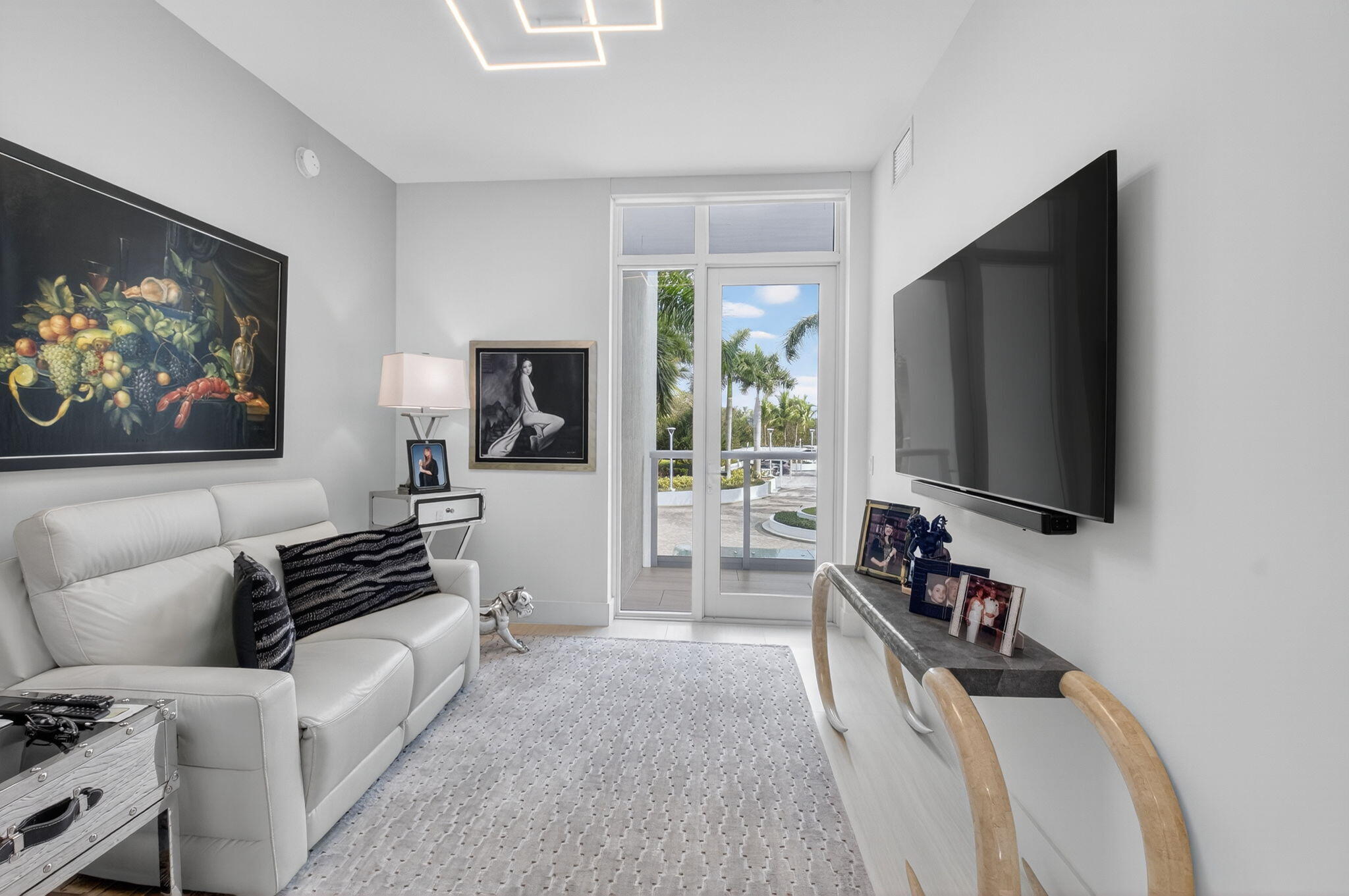 20155 Boca W Drive, Unit C205 Boca Raton, FL 33434 - Photo 40 of 122 a living room with furniture and a flat screen tv