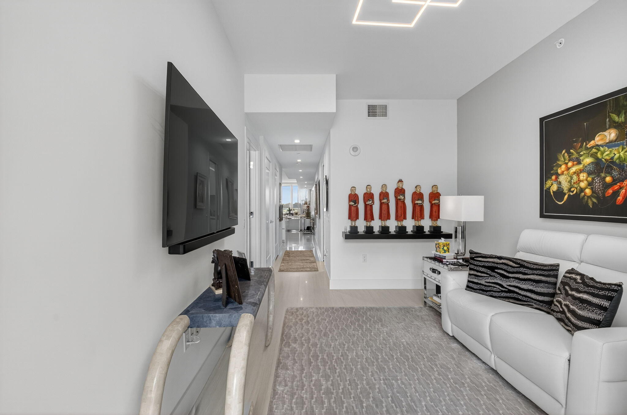 20155 Boca W Drive, Unit C205 Boca Raton, FL 33434 - Photo 42 of 122 a living room with a couch and a flat screen tv