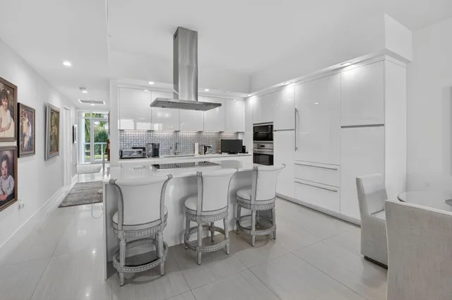 a living room with furniture and a large mirror or potted plant