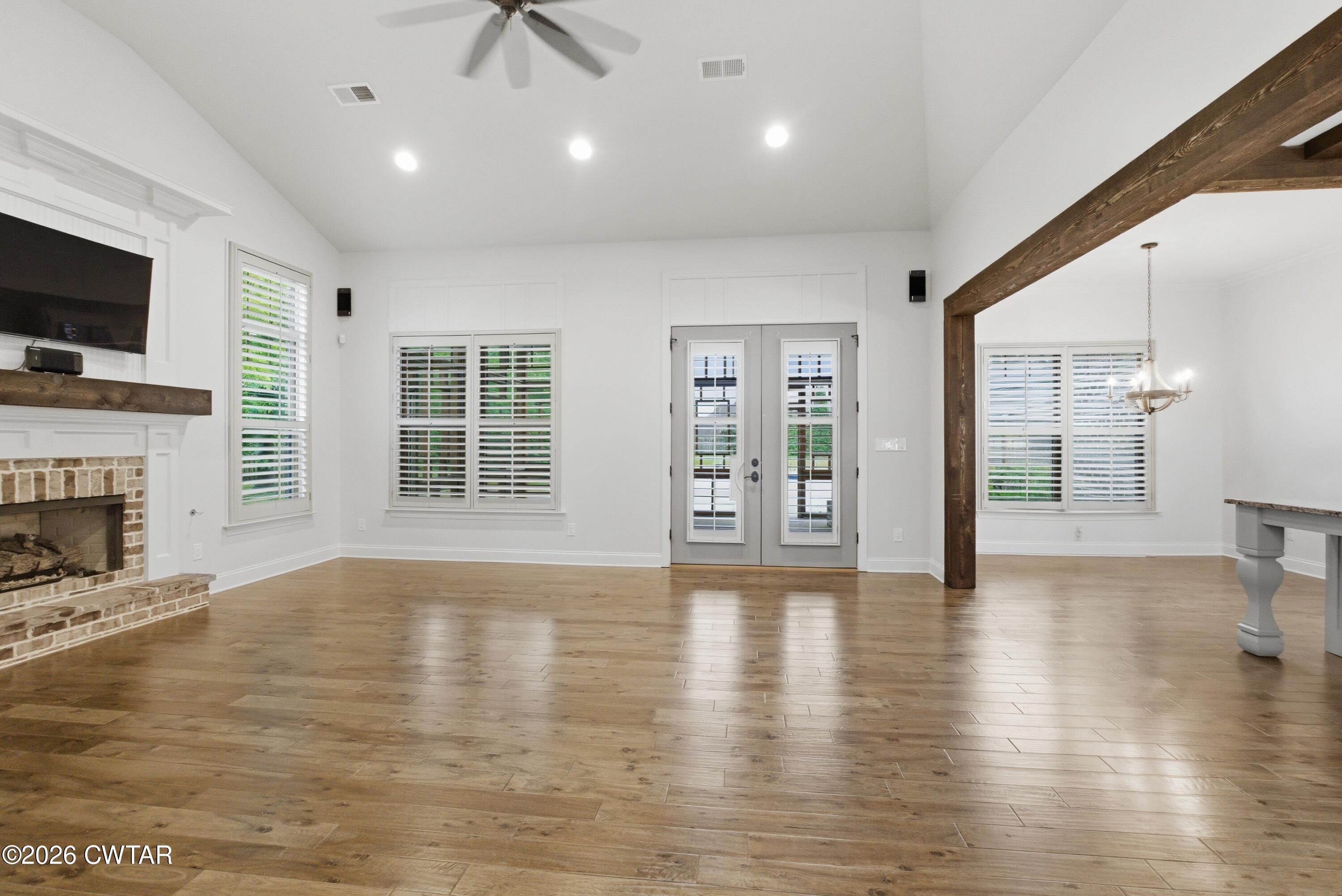 963 Ashport Road Jackson, TN 38305 - Photo 11 of 60 a view of an empty room with a fireplace and a window