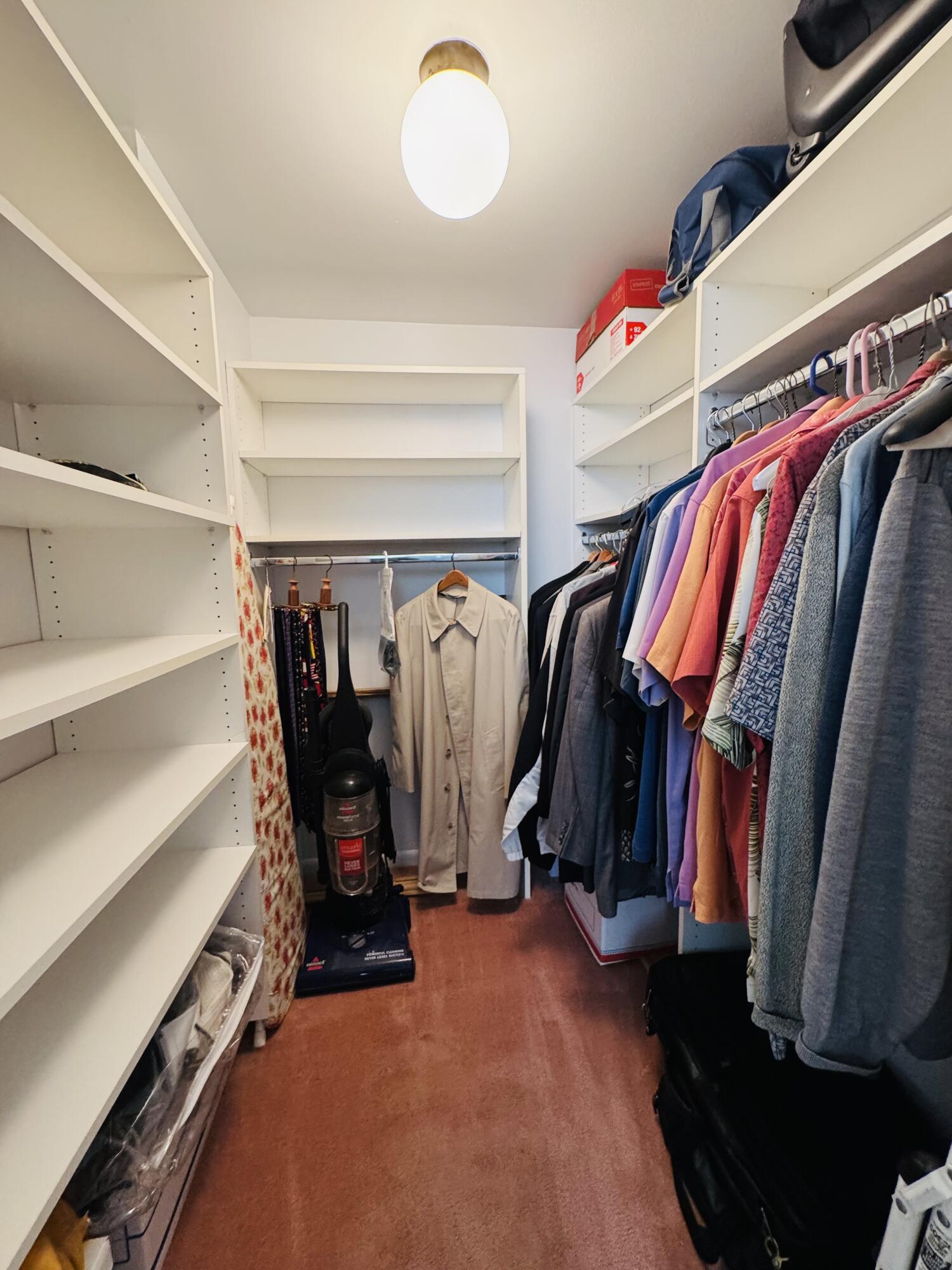 2430 DC Country Club Boulevard, Unit 4072 Deerfield Beach, FL 33442 - Photo 12 of 28 a view of walk in closet with clothes and shoes