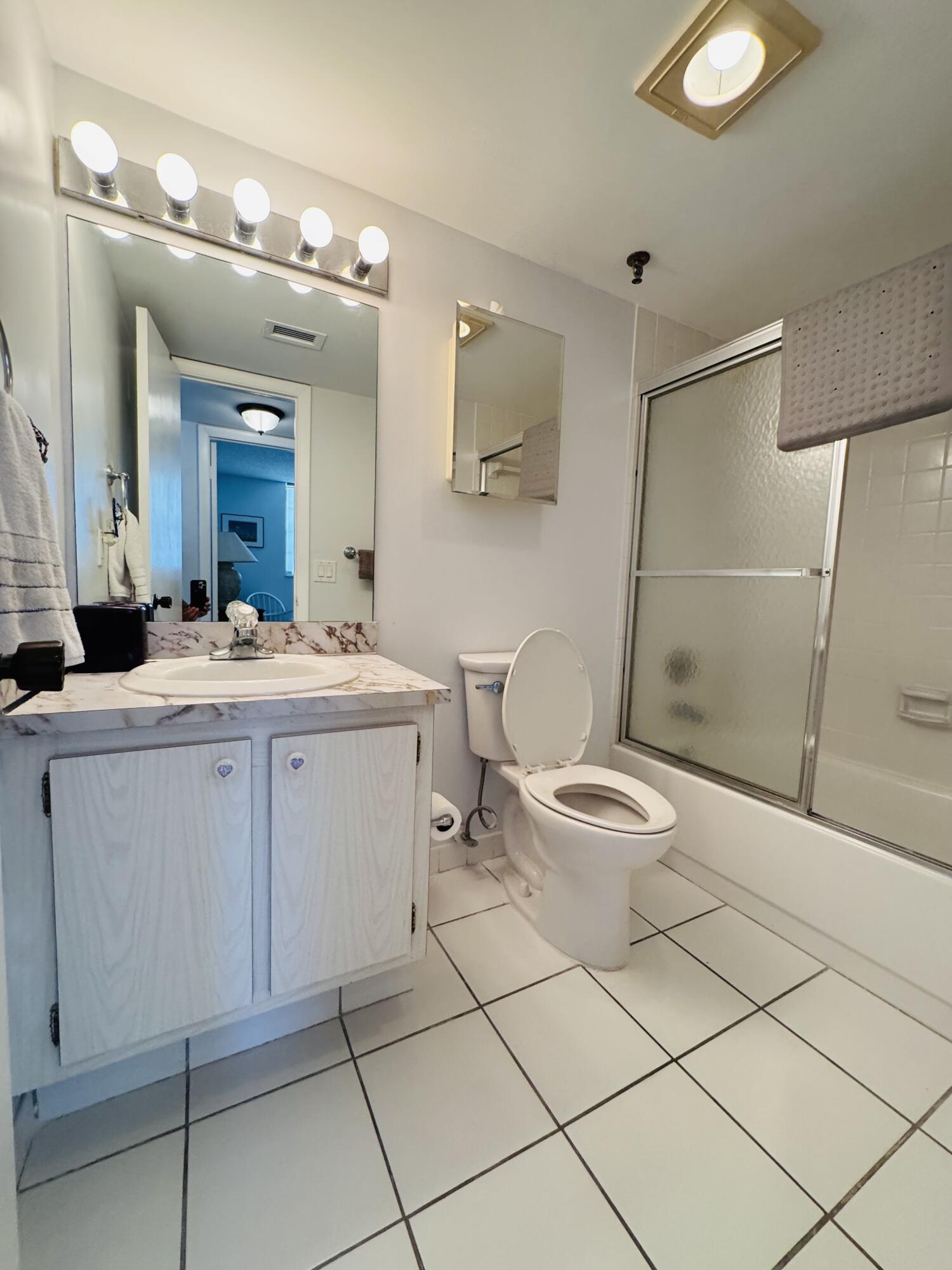 2430 DC Country Club Boulevard, Unit 4072 Deerfield Beach, FL 33442 - Photo 13 of 28 a bathroom with a toilet sink and mirror