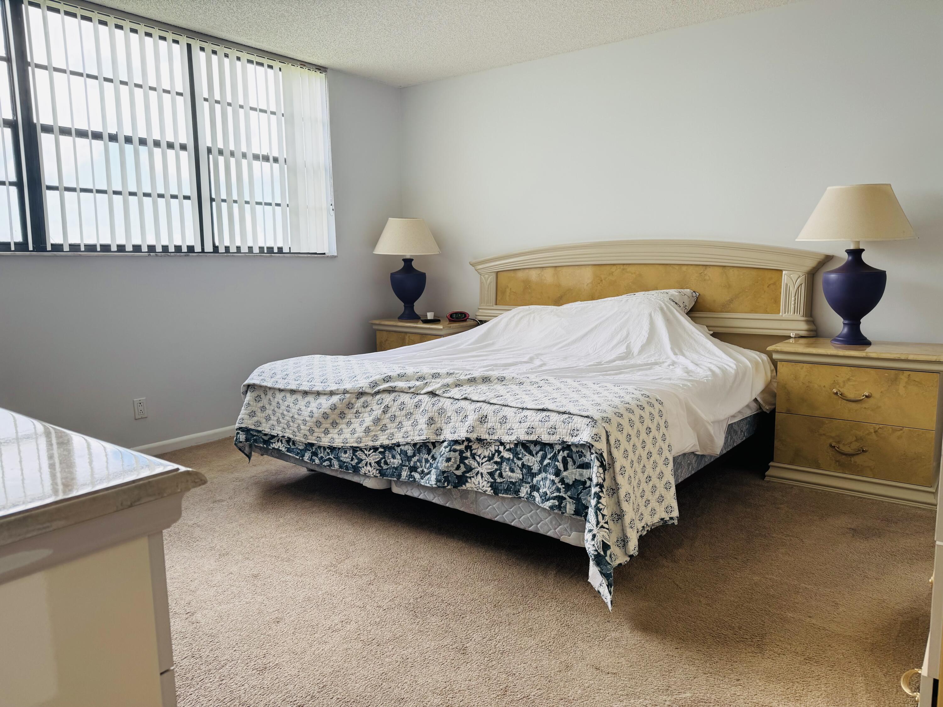 2430 DC Country Club Boulevard, Unit 4072 Deerfield Beach, FL 33442 - Photo 14 of 28 a bedroom with a bed and window