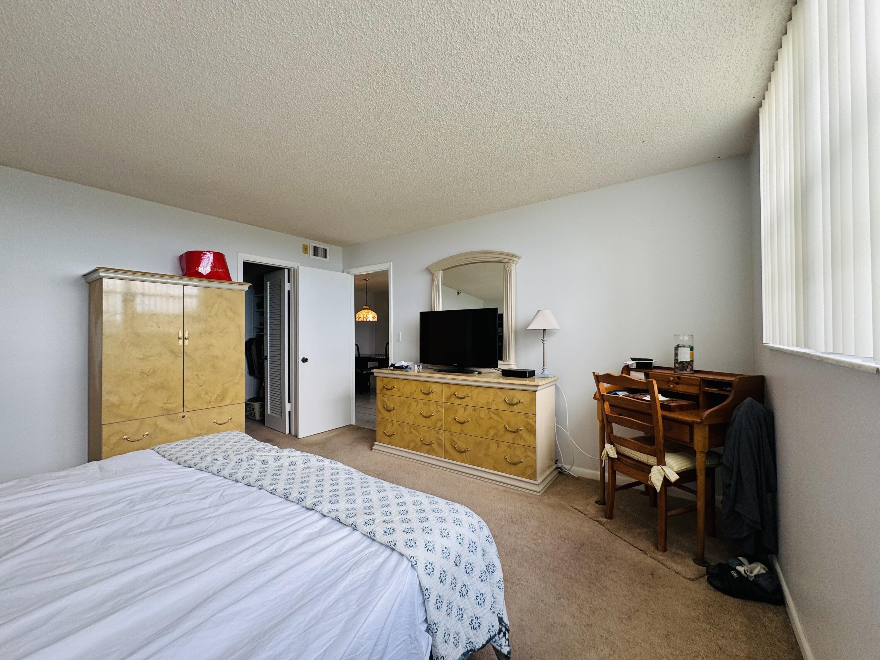 2430 DC Country Club Boulevard, Unit 4072 Deerfield Beach, FL 33442 - Photo 15 of 28 a bedroom with a bed and a flat screen tv