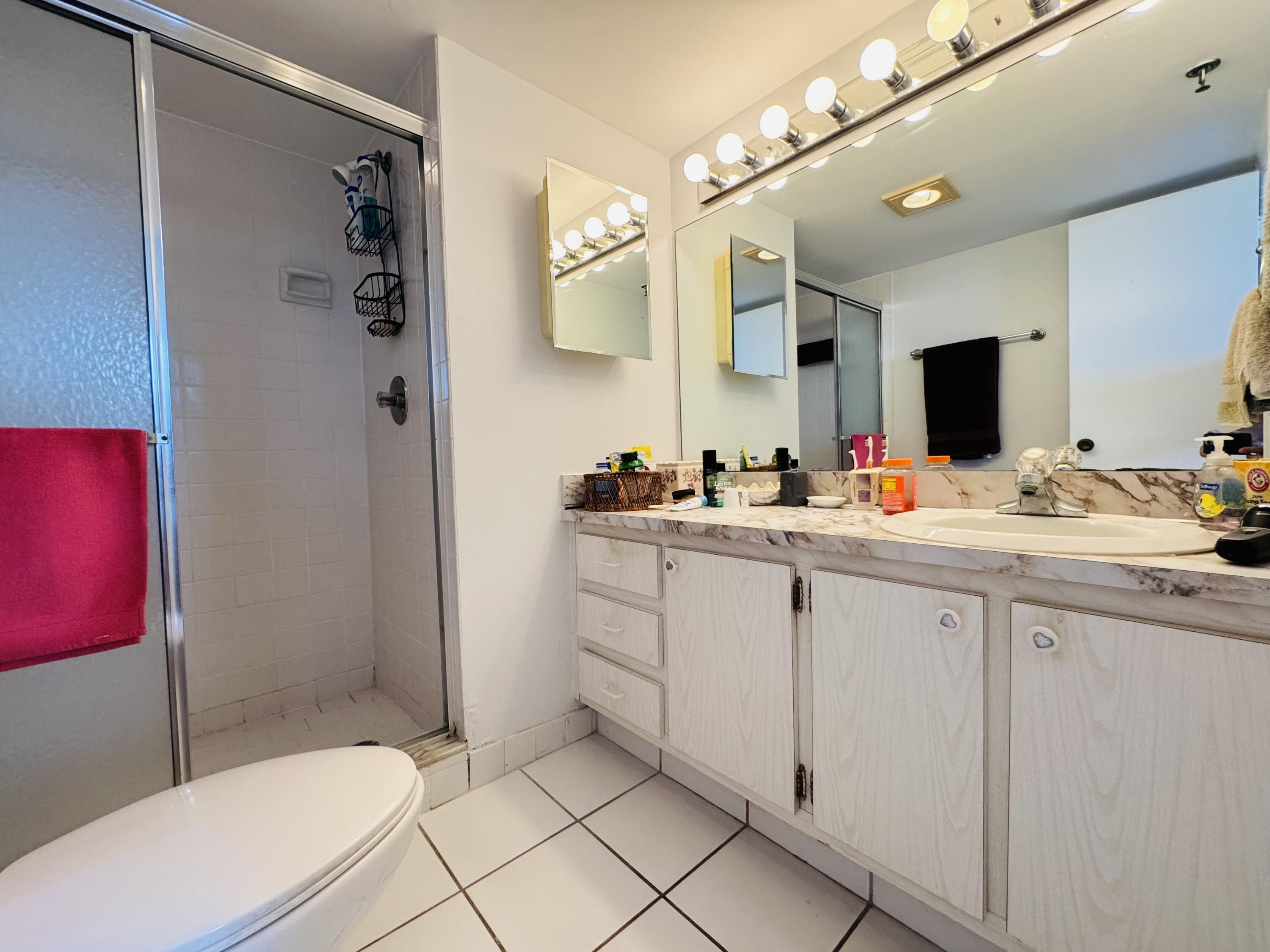 2430 DC Country Club Boulevard, Unit 4072 Deerfield Beach, FL 33442 - Photo 16 of 28 a bathroom with a sink a toilet and shower